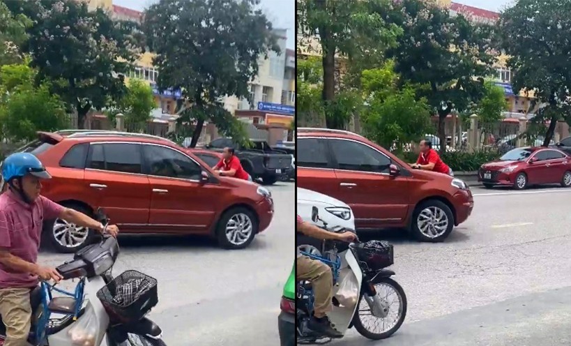 Hình ảnh người đàn ông đu bám đầu xe ô tô khi xe đang di chuyển - Ảnh cắt từ clip.