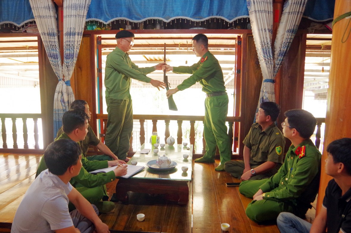 Người dân giao nộp khẩu súng tự chế cho Công an xã Phú Đình, huyện Định Hóa. (Ảnh: CATN)