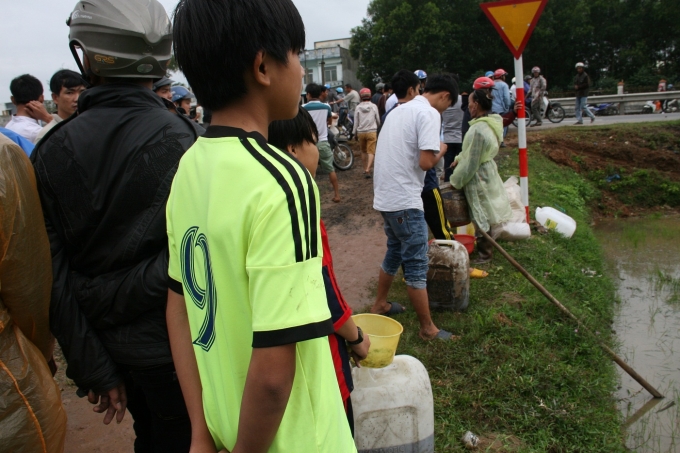 Nhiều người mang canh ra để hứng dầu.