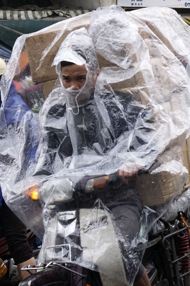 Những người chở h&agrave;ng vất vả hơn nhiều khi vừa chống ướt cho bản th&acirc;n vừa bảo đảm kh&ocirc; r&aacute;o cho h&agrave;ng h&oacute;a.