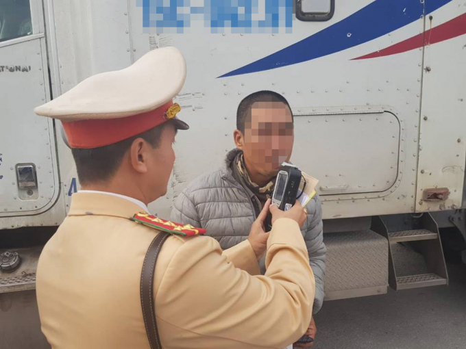 CSGT kiểm tra nồng độ cồn của t&agrave;i xế. Ảnh: Nhị Tiến.