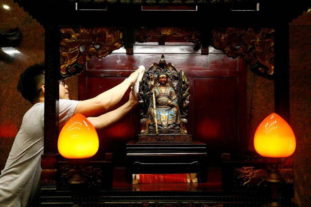 Người đàn ông lau tượng Phật ở Jakarta, Indonesia.