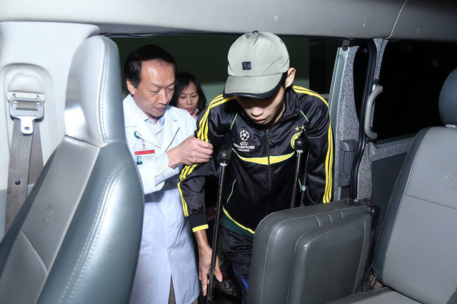 &Ocirc;ng &acirc;n cần d&igrave;u một thanh ni&ecirc;n trẻ phải chống nạng l&ecirc;n xe.