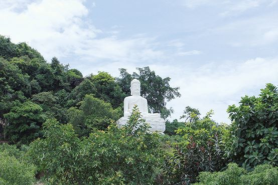 Tượng Phật b&agrave; m&agrave;u trắng nằm tr&ecirc;n con đường dẫn v&agrave;o ch&ugrave;a Tam Ch&uacute;c.&nbsp;