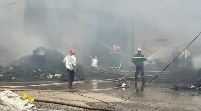 Lực lượng chức năng nỗ lực dập đ&aacute;m ch&aacute;y tại vựa phế liệu (Ảnh: Nguyễn Hảo)