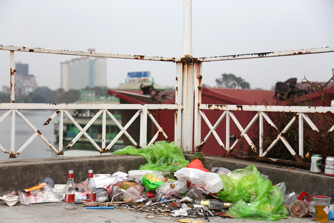 Người d&acirc;n tập kết r&aacute;c tr&ecirc;n n&oacute;c ng&ocirc;i nh&agrave; hoang ở ven hồ.