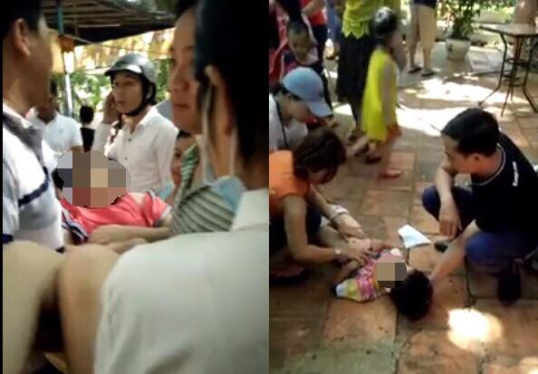 Hai ch&aacute;u đang được mọi người sơ cứu.