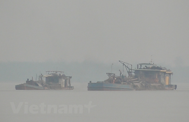 C&aacute;c t&agrave;u h&uacute;t sau khi d&ugrave;ng v&ograve;i rồng h&uacute;t c&aacute;t, sẽ được s&agrave;ng lọc để lấy c&aacute;t đen, c&ograve;n r&aacute;c đổ lại xuống s&ocirc;ng. (Ảnh: PV/Vietnam+)