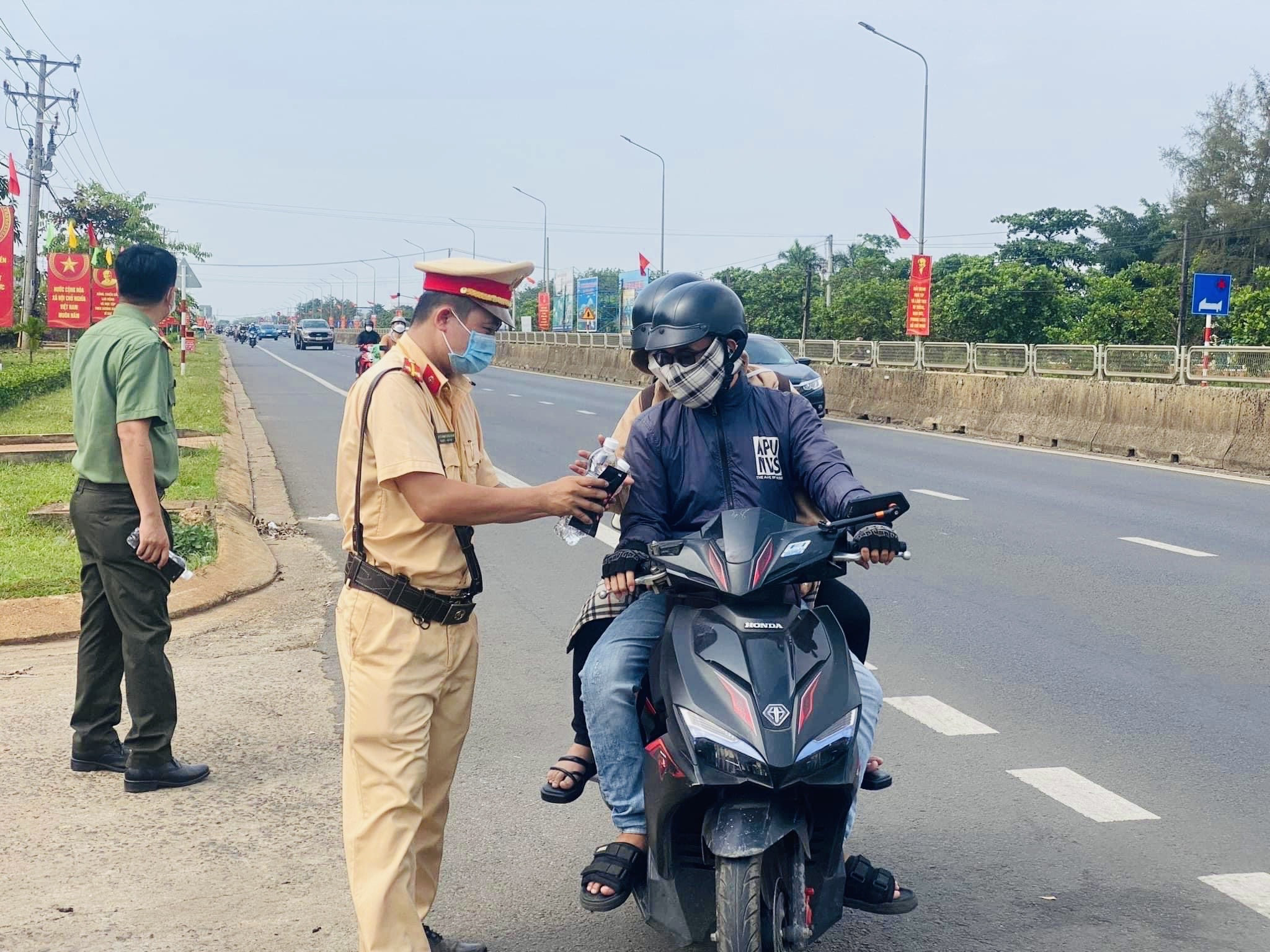 Bà con nhân dân cảm thấy ấm lòng, vui vẻ khi nhận những chai nước suối, khăn lạnh nghĩa tình