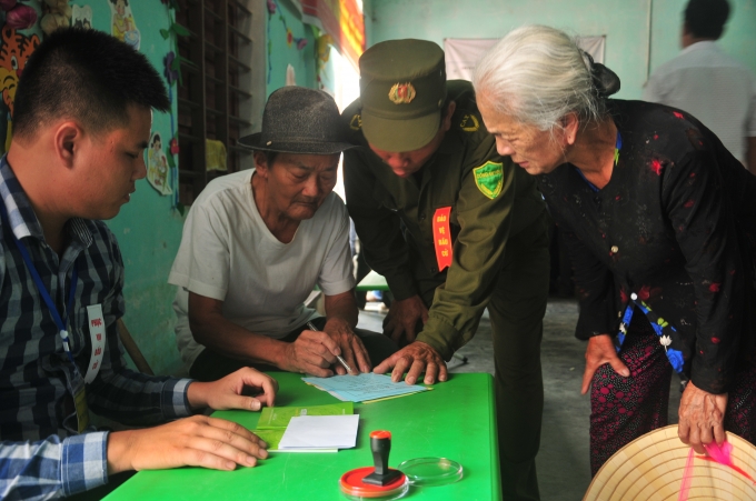 Mỗi l&aacute; phiếu được c&aacute;c cử tri kiểm tra đi kiểm tra lại kỹ lưỡng dưới sự huớng dẫn của tổ bầu cử. D&ugrave; mắt kh&ocirc;ng nh&igrave;n r&otilde; tay run nhưng nhiều cụ vẫn muốn tự tay bầu chọn những đại biểu ưu t&uacute; nhất cho đất nước.