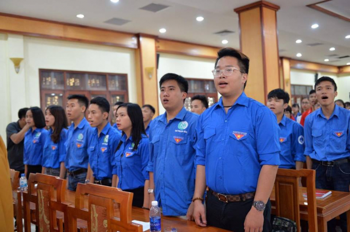 C&aacute;c bạn t&igrave;nh nguyện thuộc đo&agrave;n TNCS HCM đứng dậy h&aacute;t Quốc Ca với kh&ocirc;ng kh&iacute; trang nghi&ecirc;m.