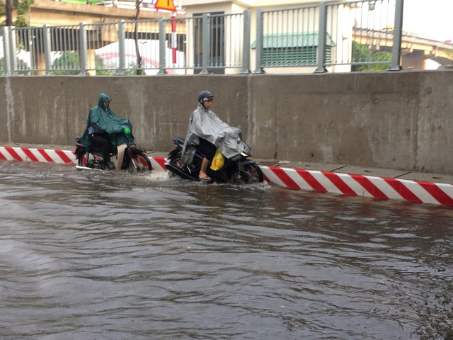 Người d&acirc;n b&igrave; b&otilde;m sau cơn mưa tại hầm chui B&igrave;nh Triệu