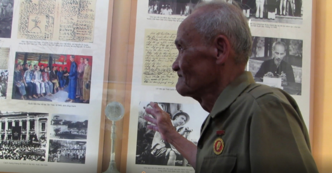 Cụ Phước đang giới thiệu c&aacute;c mốc lịch sử, sự kiện với kh&aacute;ch tham quan.