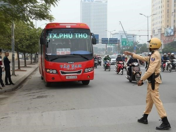 Cảnh s&aacute;t giao th&ocirc;ng xử l&yacute; trường hợp xe kh&aacute;ch vi phạm tr&ecirc;n đường Phạm H&ugrave;ng. (Ảnh: Do&atilde;n Tấn/TTXVN).