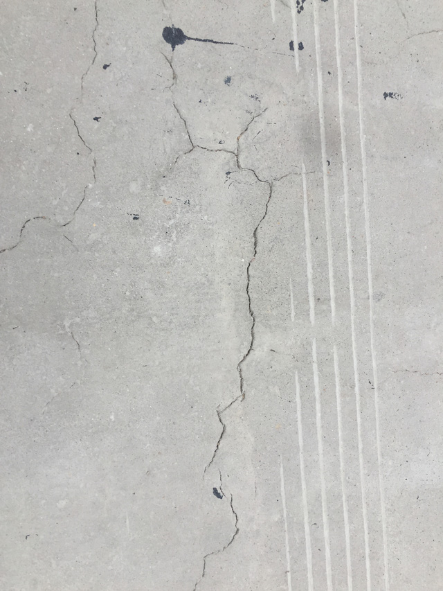 Xuất hiện nhiều vết nứt k&eacute;o d&agrave;i tr&ecirc;n mặt đường b&ecirc; t&ocirc;ng.