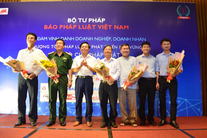 Đại diện l&atilde;nh đạo B&aacute;o Ph&aacute;p luật Việt Nam tặng hoa cho c&aacute;c đại diện Sở ban ng&agrave;nh TP. Đ&agrave; Nẵng v&agrave; Bộ tư l&ecirc;nh Qu&acirc;n khu 5 tham dự Tọa đ&agrave;m.