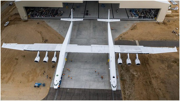 Stratolaunch l&agrave; m&aacute;y bay lớn nhất thế giới t&iacute;nh đến nay. Với sải c&aacute;nh 117 m vượt chiều d&agrave;i hơn cả chiều d&agrave;i của một s&acirc;n b&oacute;ng đ&aacute;, đ&acirc;y l&agrave; sản phẩm của c&ocirc;ng ty h&agrave;ng kh&ocirc;ng vũ trụ Stratolaunch Systems (Mỹ). Chiếc Stratolaunch c&oacute; trọng lượng gần 227 tấn khi kh&ocirc;ng chở h&agrave;ng, trọng lượng cất c&aacute;nh tối đa gần 590 tấn. M&aacute;y bay di chuyển tr&ecirc;n mặt đất nhờ 28 b&aacute;nh xe v&agrave; bằng 6 động cơ Boeing 747 khi ở tr&ecirc;n kh&ocirc;ng trung. K&iacute;ch thước lớn vượt trội cho ph&eacute;p m&aacute;y bay n&agrave;y c&oacute; thể hoạt động như một bệ ph&oacute;ng t&ecirc;n lửa tr&ecirc;n kh&ocirc;ng. Stratolaunch dự kiến sẽ cất c&aacute;nh lần đầu v&agrave;o năm 2019. (Ảnh: Stratolaunch)