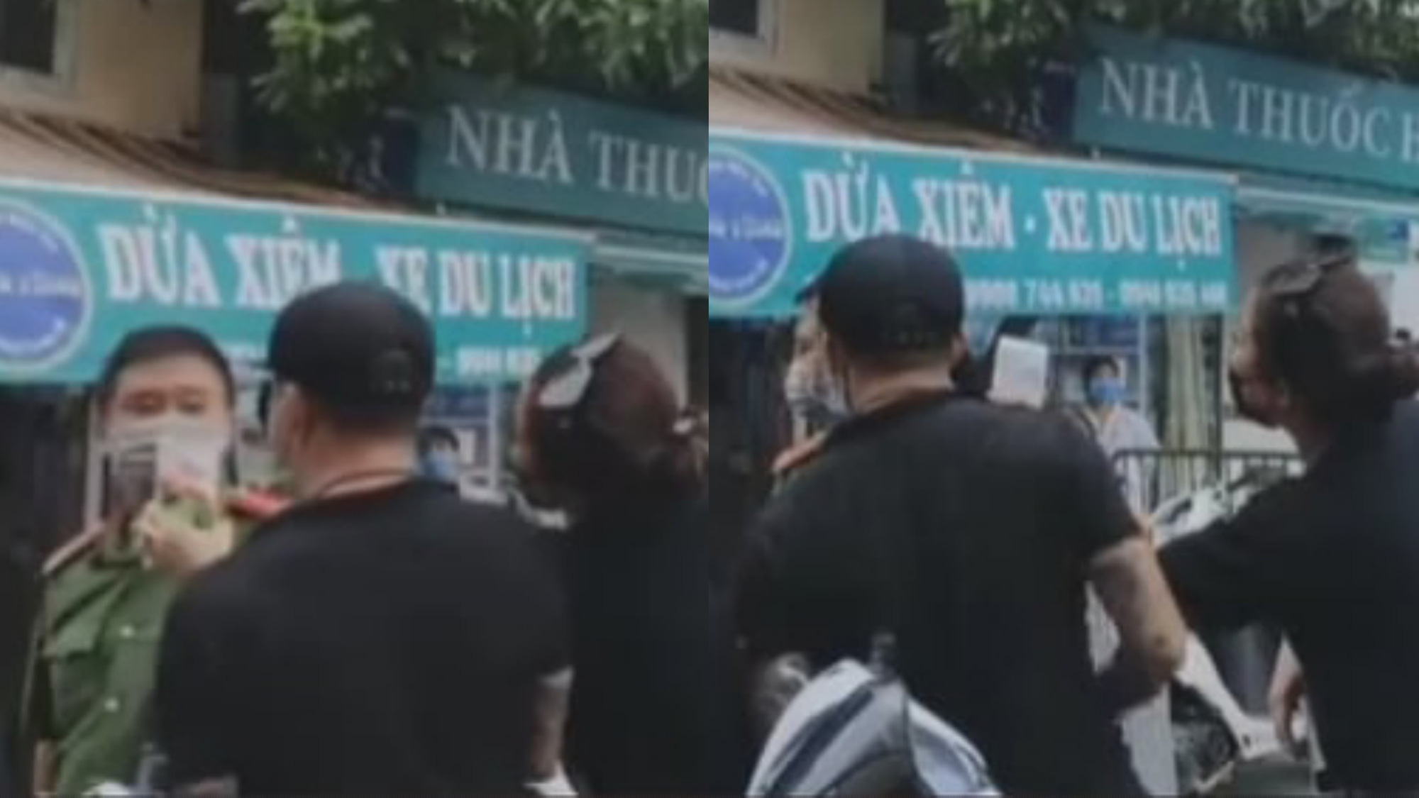 Người phụ nữ liên tục dùng điện thoại quay và dí thẳng vào mặt cán bộ công an tại chốt kiểm soát, căn vặn nhiều câu hỏi khi không được lực lượng cho vào chợ. (Ảnh cắt từ clip)