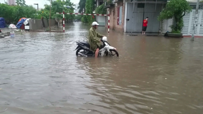 Tại đường Chiến Thắng (H&agrave; Đ&ocirc;ng), nước ngập d&acirc;ng cao đến qu&aacute; vỉa h&egrave; l&agrave;m c&aacute;c phương tiện khi di chuyển qua đ&acirc;y gặp nhiều kh&oacute; khăn. Ảnh: Huy Trung