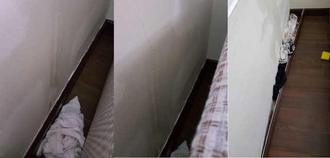 Tường nứt, nước thấm qua r&ograve; v&agrave;o nh&agrave; khiến cư d&acirc;n phải d&ugrave;ng chất liệu vải để thấm, ngăn nước. Ảnh: Cư d&acirc;n cung cấp.