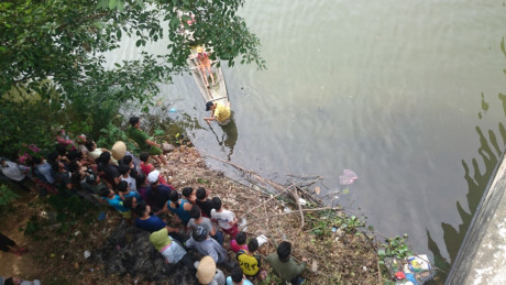 Nhiều người d&acirc;n theo d&otilde;i sự việc ở gầm cầu.