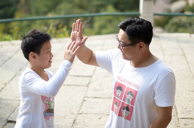 Hai thầy tr&ograve; vui vẻ đập tay khi chạm mốc 900 m của ngọn n&uacute;i.&nbsp;(Ảnh: China Daily)