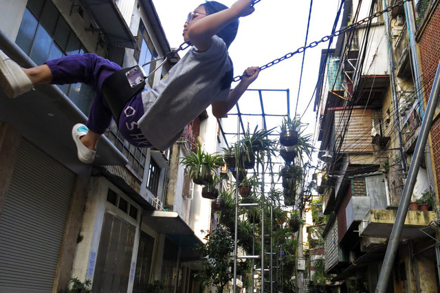 Trẻ em trong ng&otilde; 167 vui chơi dưới b&oacute;ng m&aacute;t của vườn hoa treo, được gọi l&agrave; vườn hoa cộng đồng. Đ&acirc;y l&agrave; một sản phẩm của Đo&agrave;n thanh ni&ecirc;n b&aacute;o H&agrave; Nội Mới thực hiện.