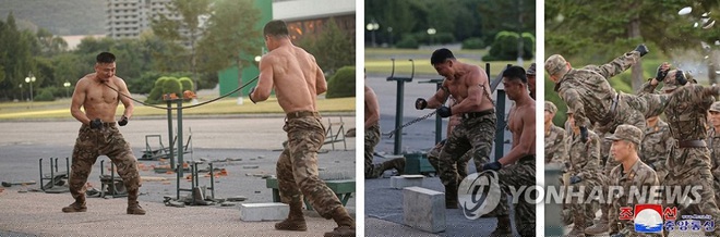 C&aacute;c binh sĩ d&ugrave;ng thanh sắt d&ugrave;ng cổ họng uốn cong thanh sắt (Ảnh: Yonhap).