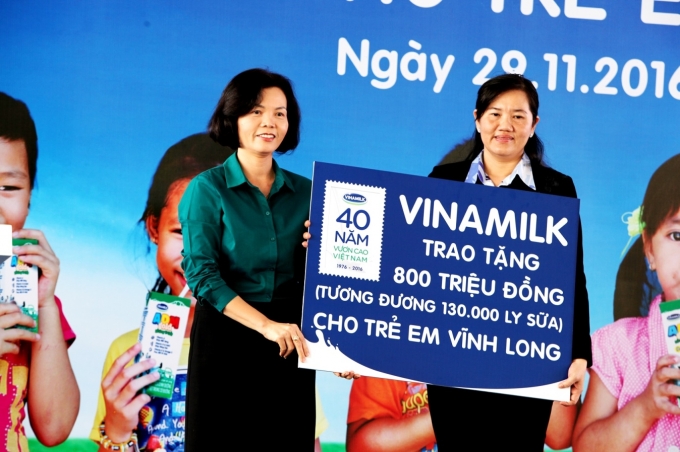 B&agrave; B&ugrave;i Thị Hương &ndash; Gi&aacute;m Đốc Điều h&agrave;nh Vinamilk trao tặng bảng tượng trưng 130.000 ly sữa với tổng trị gi&aacute; 800 triệu đồng&nbsp;của Quỹ Sữa Vươn Cao Việt Nam cho học sinh ngh&egrave;o Vĩnh Long.