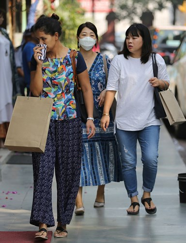 Những người đi mua sắm trong một khu chợ phải đeo khẩu trang để đối ph&oacute; với t&igrave;nh trạng &ocirc; nhiềm kh&ocirc;ng kh&iacute; nghi&ecirc;m trọng. Ảnh: AP