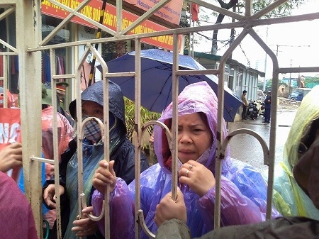 Những c&ocirc;ng nh&acirc;n bị nhốt ph&iacute;a trong dưới trời mưa như tr&uacute;t.