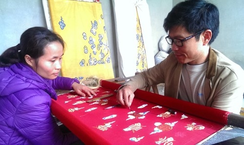 Nghệ nh&acirc;n nh&acirc;n d&acirc;n Vũ Văn Giỏi đang hướng dẫn thợ th&ecirc;u một số kỹ thuật th&ecirc;u truyền thống.