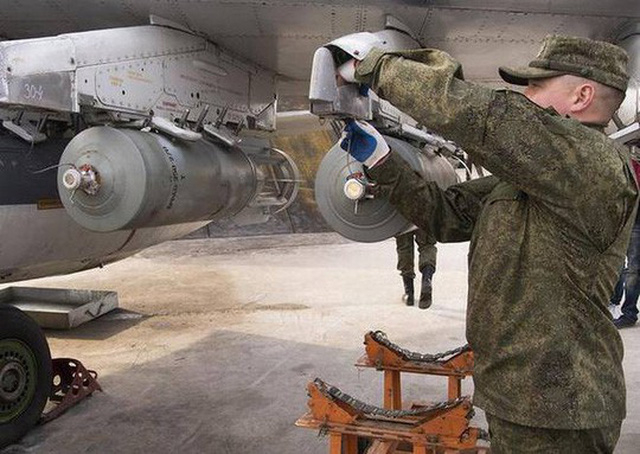 Kỹ thuật vi&ecirc;n kh&ocirc;ng qu&acirc;n Nga gắn bom v&agrave;o m&aacute;y bay tại căn cứ ở Syria. (Ảnh: AP)