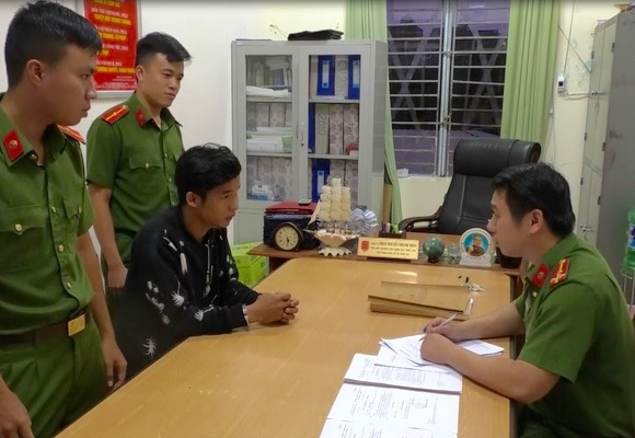 Đối tượng Th&agrave;nh (&aacute;o đen) l&agrave;m việc tại trụ sở c&ocirc;ng an.